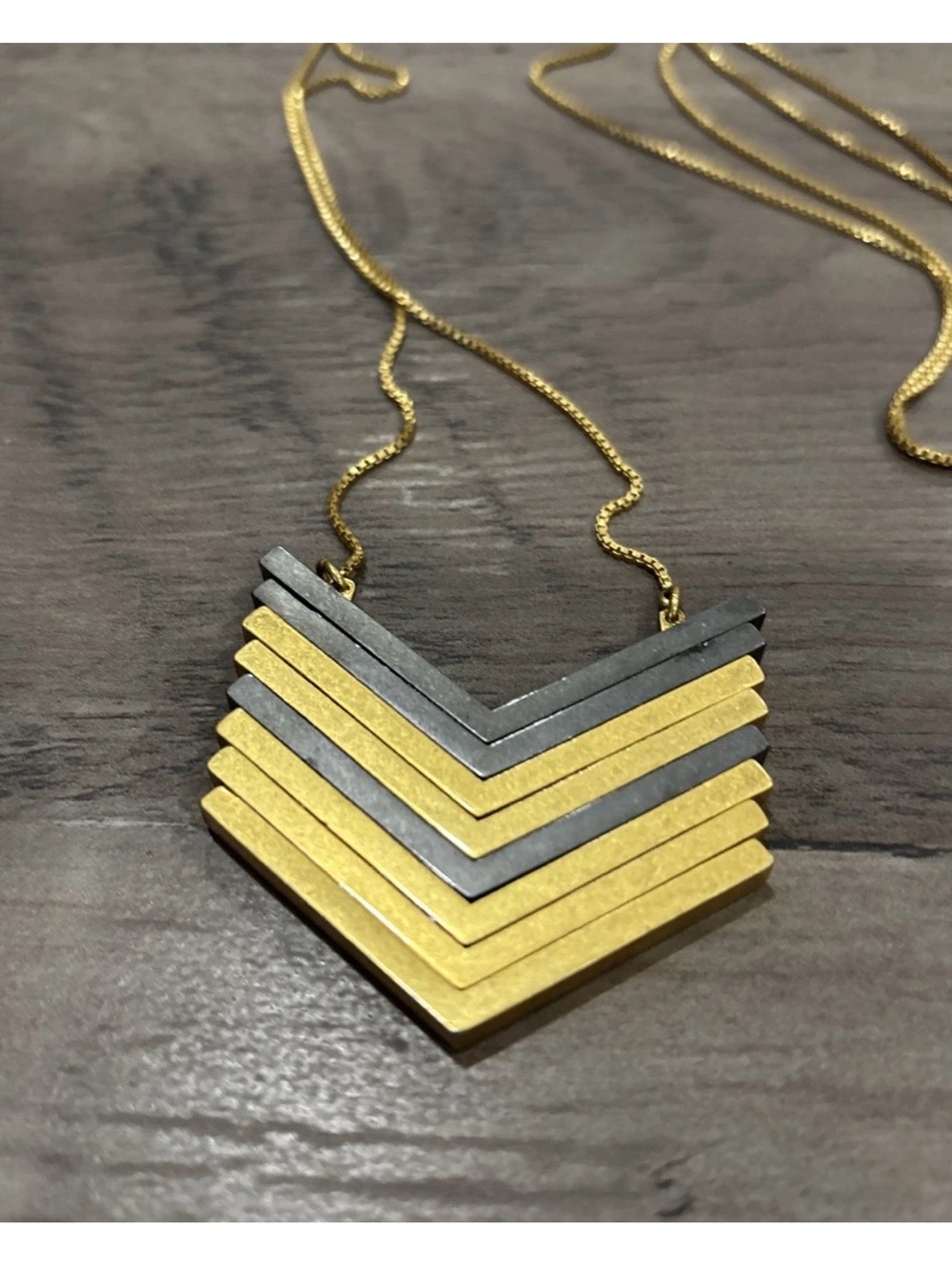 Madewell Arrowstack Chevron necklace featuring alternating gold-tone and black
